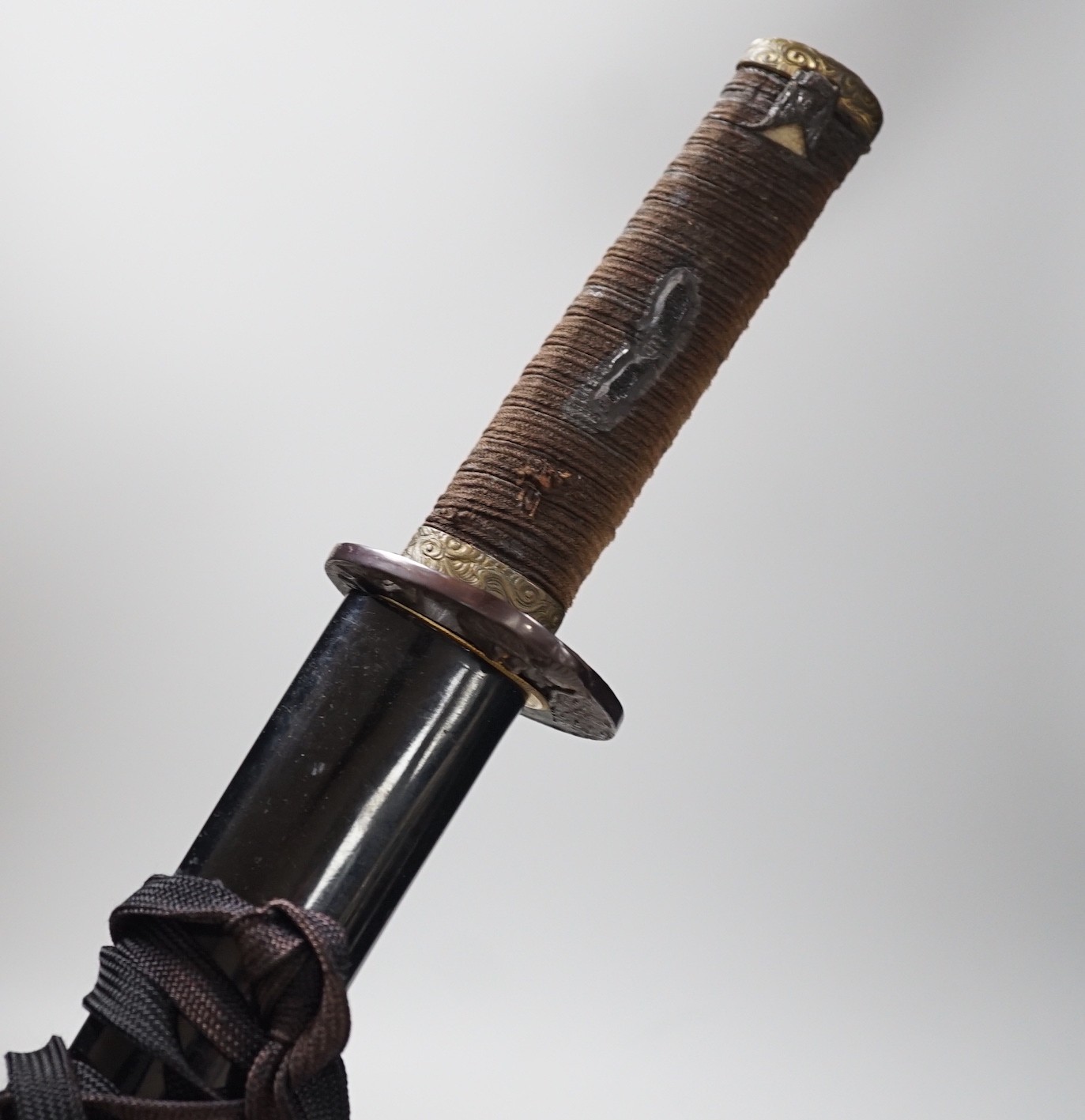 A 20th century Japanese wakizashi with cast iron ‘tiger’ tsuba, total length 73cm including scabbard